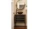 Copper sink and vanity with a large round mirror at 66 Charlou Cir, Cherry Hills Village, CO 80111
