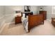 Basement bedroom with wooden bed frame and neutral decor at 66 Charlou Cir, Cherry Hills Village, CO 80111