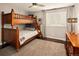 Well-lit bedroom featuring a wooden bunk bed and ample floor space at 66 Charlou Cir, Cherry Hills Village, CO 80111