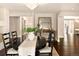 Elegant dining room features a large table, chandelier, and access to a deck at 66 Charlou Cir, Cherry Hills Village, CO 80111