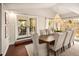 Bright dining room with hardwood floors, large table, and French doors at 66 Charlou Cir, Cherry Hills Village, CO 80111