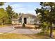 Brick two-story home with circular driveway and landscaped yard at 66 Charlou Cir, Cherry Hills Village, CO 80111