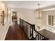 Bright hallway with hardwood floors and elegant light fixture at 66 Charlou Cir, Cherry Hills Village, CO 80111
