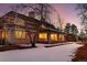 Exterior view of a two-story home at dusk with snow on the ground at 66 Charlou Cir, Cherry Hills Village, CO 80111