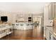 Open kitchen with large island and breakfast bar, views to dining area at 66 Charlou Cir, Cherry Hills Village, CO 80111