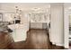 Spacious kitchen boasts white cabinets, large island, and hardwood floors at 66 Charlou Cir, Cherry Hills Village, CO 80111