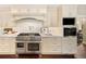 High-end kitchen features a large range and stainless steel appliances at 66 Charlou Cir, Cherry Hills Village, CO 80111