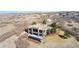 Modern two-story home with a swimming pool set on a vast, arid landscape with sparse vegetation at 3219 Castle Butte Dr, Castle Rock, CO 80109