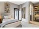 Well-lit bedroom featuring carpet, a large mirror and easy access to an ensuite bath at 3219 Castle Butte Dr, Castle Rock, CO 80109