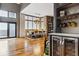 Open dining room with hardwood floors, a wine fridge and large windows with ample natural light at 3219 Castle Butte Dr, Castle Rock, CO 80109