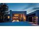 Stunning modern home exterior with a concrete driveway and a stone accent at twilight at 3219 Castle Butte Dr, Castle Rock, CO 80109