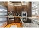 Modern kitchen with stainless steel appliances, granite countertops, and custom cabinetry at 3219 Castle Butte Dr, Castle Rock, CO 80109