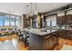 Modern kitchen with a large island, marble countertops, and an adjacent dining area with ample natural light at 3219 Castle Butte Dr, Castle Rock, CO 80109
