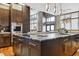 Gourmet kitchen featuring a large island with seating, stainless steel appliances, and stylish pendant lighting at 3219 Castle Butte Dr, Castle Rock, CO 80109
