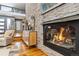 Living room featuring a cozy fireplace with stone surround and hardwood floors at 3219 Castle Butte Dr, Castle Rock, CO 80109