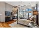 Bedroom featuring a fireplace, large windows with amazing natural light, and hardwood floors at 3219 Castle Butte Dr, Castle Rock, CO 80109