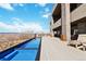 Long pool next to a deck with mountain views under a blue sky at 3219 Castle Butte Dr, Castle Rock, CO 80109