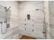 Clean shower featuring wall mounted shower heads, and a wooden bench at 3219 Castle Butte Dr, Castle Rock, CO 80109
