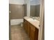 Standard bathroom with shower-tub combo and tile flooring at 4580 W Alameda Ave, Denver, CO 80219