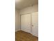 Bedroom features white closet doors and wood-look flooring at 4580 W Alameda Ave, Denver, CO 80219