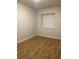 Bedroom with window and wood-look flooring at 4580 W Alameda Ave, Denver, CO 80219