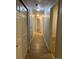 Long hallway with light-colored walls, and wood-look flooring, leading to other rooms at 4580 W Alameda Ave, Denver, CO 80219
