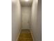 Hallway with light-colored walls and tile flooring leading to the front door at 4580 W Alameda Ave, Denver, CO 80219
