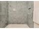 Bathroom featuring blue tile shower, white tub, and recessed niche at 8335 Fairmount Dr # 7-208, Denver, CO 80247