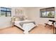 Inviting bedroom with light wood floors, large windows, and modern decor at 8335 Fairmount Dr # 7-208, Denver, CO 80247