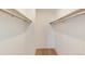 Spacious walk-in closet with wooden floors and ample shelving for organized storage at 8335 Fairmount Dr # 7-208, Denver, CO 80247