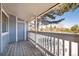 Inviting deck with wooden railing, blue siding, and scenic views at 8335 Fairmount Dr # 7-208, Denver, CO 80247