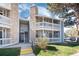 Charming condo building with multiple balconies, stone accents, and mature trees at 8335 Fairmount Dr # 7-208, Denver, CO 80247