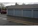 Row of detached garages with grey doors and white trim, with the unit numbers above at 8335 Fairmount Dr # 7-208, Denver, CO 80247