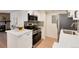 Well-equipped kitchen with stainless steel appliances, white cabinets, and a breakfast bar at 8335 Fairmount Dr # 7-208, Denver, CO 80247