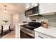 Updated kitchen with stainless steel appliances, white cabinets, and modern lighting at 8335 Fairmount Dr # 7-208, Denver, CO 80247