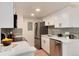 Modern kitchen featuring stainless steel appliances, white cabinetry, and sleek countertops at 8335 Fairmount Dr # 7-208, Denver, CO 80247