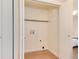 Bright laundry closet featuring white walls, hardwood floors, and washer/dryer hookups at 8335 Fairmount Dr # 7-208, Denver, CO 80247