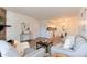 Bright living room featuring an open floor plan, stone fireplace, and comfortable seating at 8335 Fairmount Dr # 7-208, Denver, CO 80247