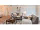 Well-lit living room with stylish decor, comfortable seating, and bright natural light at 8335 Fairmount Dr # 7-208, Denver, CO 80247