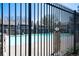 Community pool enclosed by iron fence with clear blue water and adjacent buildings at 8335 Fairmount Dr # 7-208, Denver, CO 80247