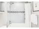 Clean bathroom with shower/tub combo and white tile at 185 S Eliot St, Denver, CO 80219