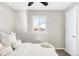 Bedroom with ceiling fan, window, and plush bedding at 185 S Eliot St, Denver, CO 80219