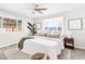 Main bedroom with ceiling fan, large window, and plush bedding at 185 S Eliot St, Denver, CO 80219