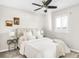 Bedroom with ceiling fan, window, and plush bedding at 185 S Eliot St, Denver, CO 80219