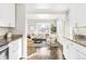 Open kitchen with granite countertops and white cabinets at 185 S Eliot St, Denver, CO 80219