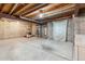 Unfinished basement space with concrete floor, exposed ceiling, with utilities and ample room for storage at 8095 Garrison Ct # B, Arvada, CO 80005