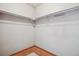 Empty walk-in closet with wood floor trim and a clothing rod, ready to be organized for optimal storage at 8095 Garrison Ct # B, Arvada, CO 80005