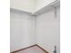 Empty closet with white walls, wood floor trim, a carpet floor, and a clothing rod for hanging clothes at 8095 Garrison Ct # B, Arvada, CO 80005