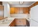 Functional kitchen with oak cabinets and white appliances at 8095 Garrison Ct # B, Arvada, CO 80005