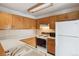 Functional kitchen featuring classic oak cabinetry, white countertops, and standard appliances at 8095 Garrison Ct # B, Arvada, CO 80005